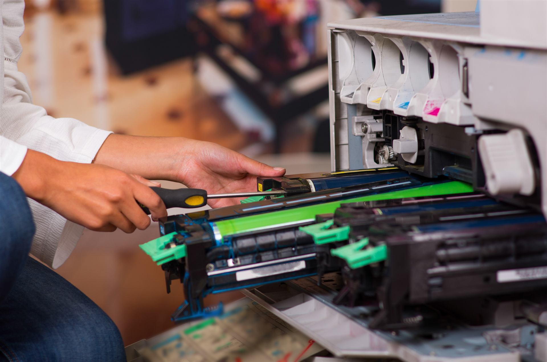 Essential Technical Solutions technician servicing a color copier's toner and drum cartridges